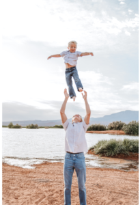 Older brother throwing younger brother into the air