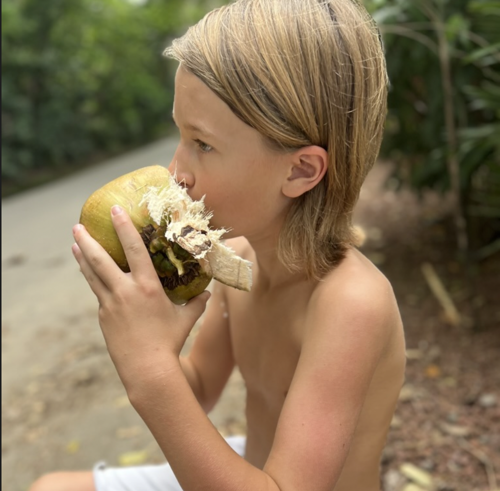 boy drinking from coconut